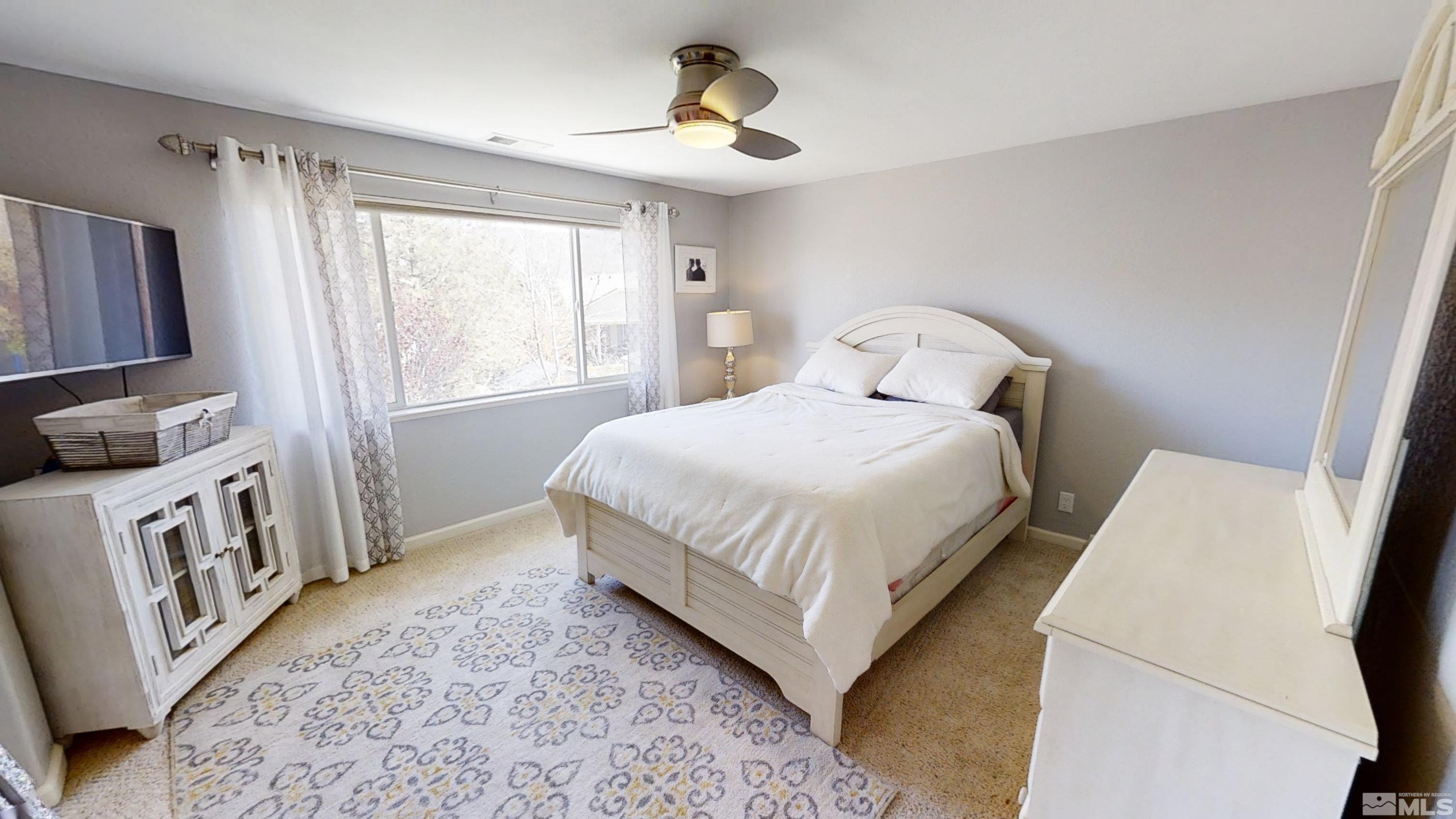 10018 Silver Star Drive Reno, NV 89521 - Photo 17 of 38 a bedroom with a bed and a window