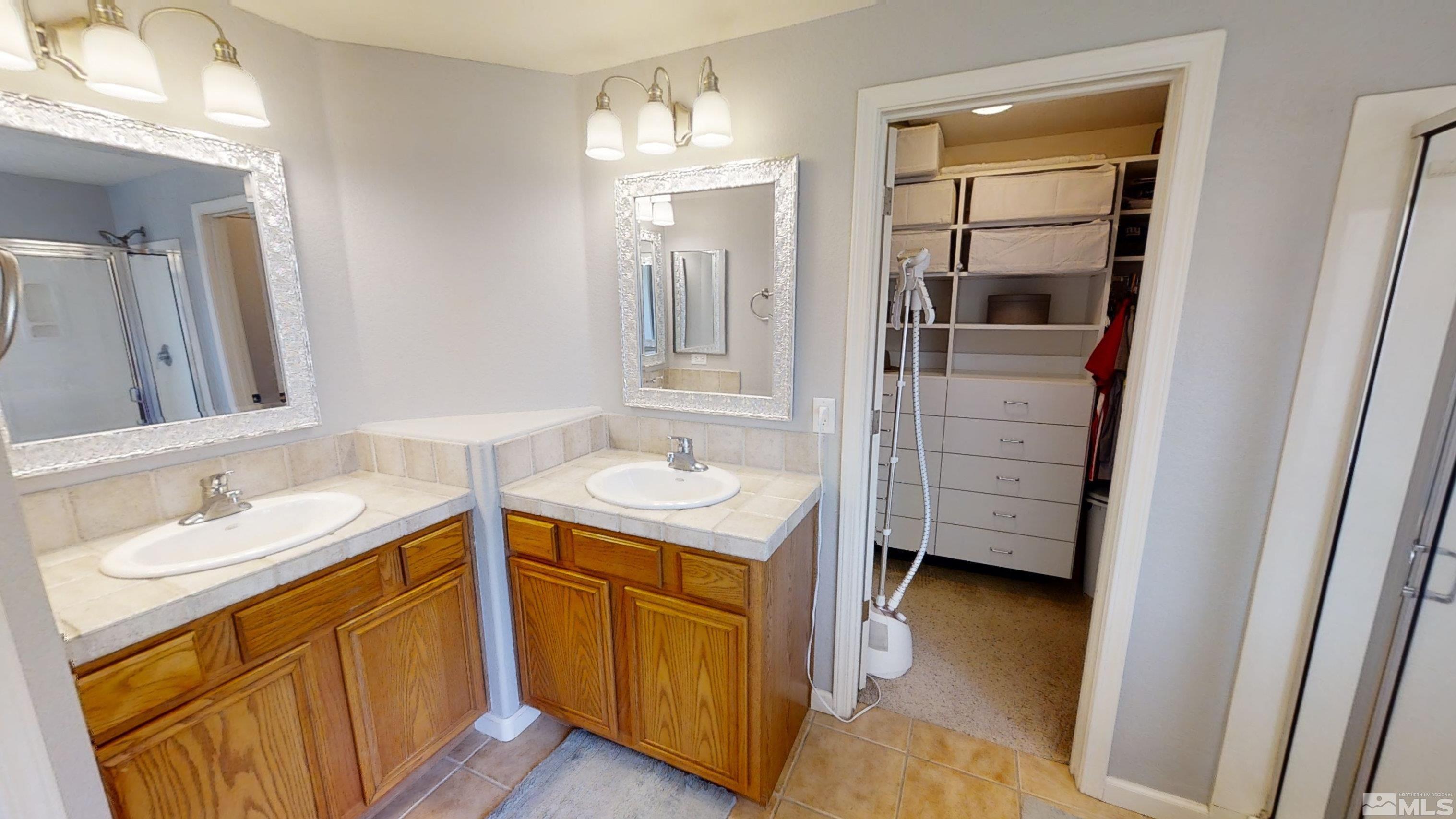 10018 Silver Star Drive Reno, NV 89521 - Photo 20 of 38 a bathroom with a sink a vanity and mirror