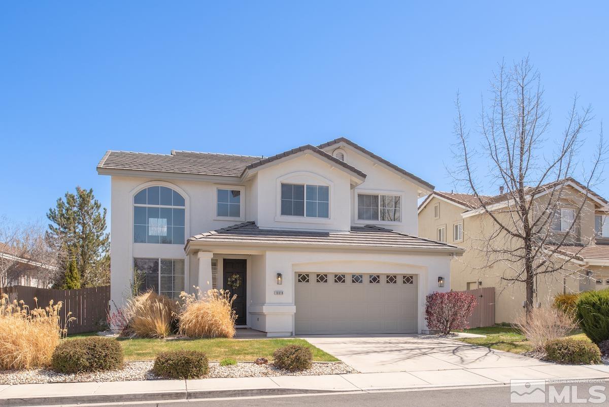 10018 Silver Star Drive Reno, NV 89521 - Photo 2 of 38 a view of a white house with a large windows