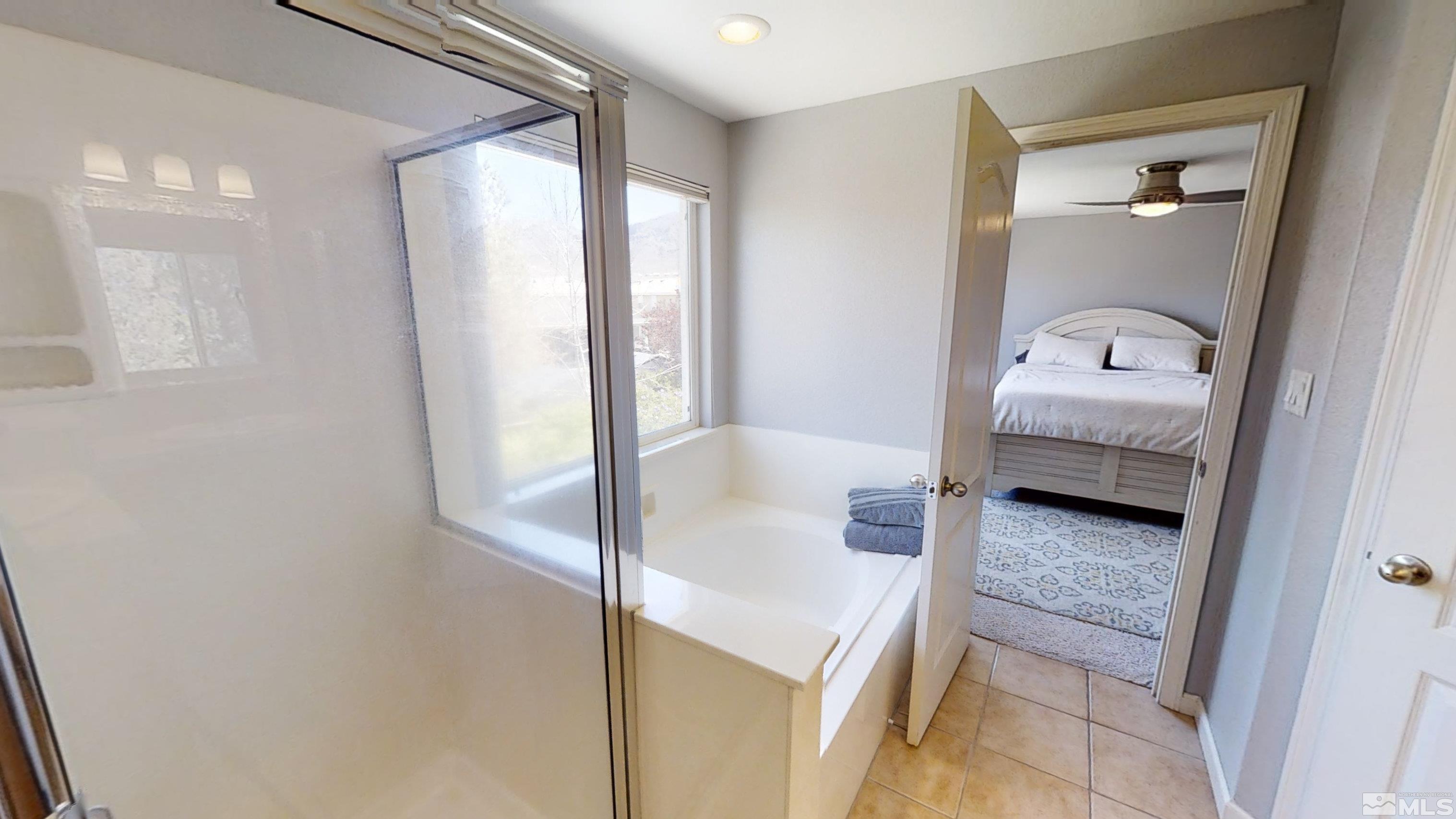 10018 Silver Star Drive Reno, NV 89521 - Photo 22 of 38 a en suite bathroom with a granite countertop sink and a mirror