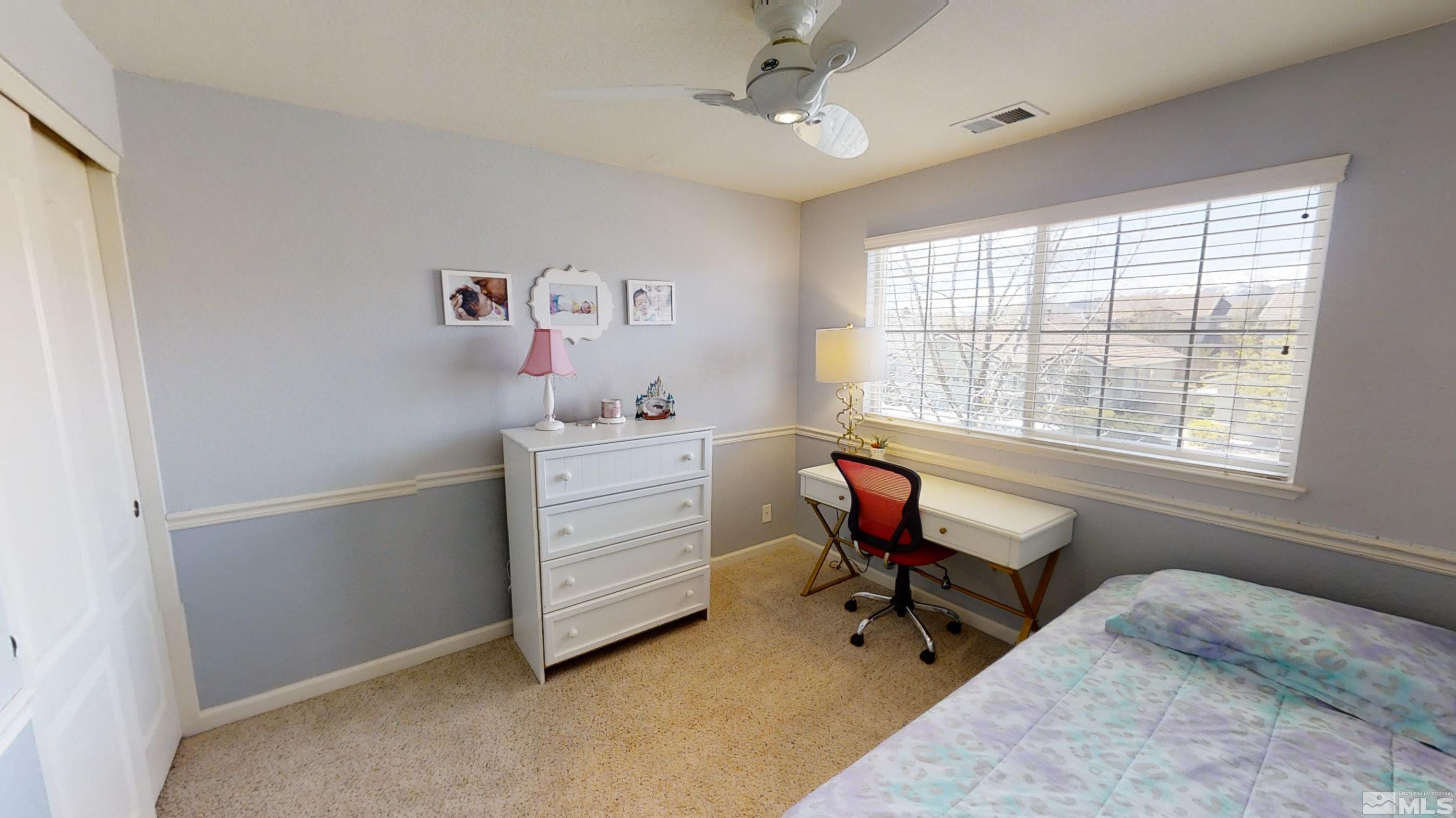 10018 Silver Star Drive Reno, NV 89521 - Photo 24 of 38 a room that has a bed and a chair in it