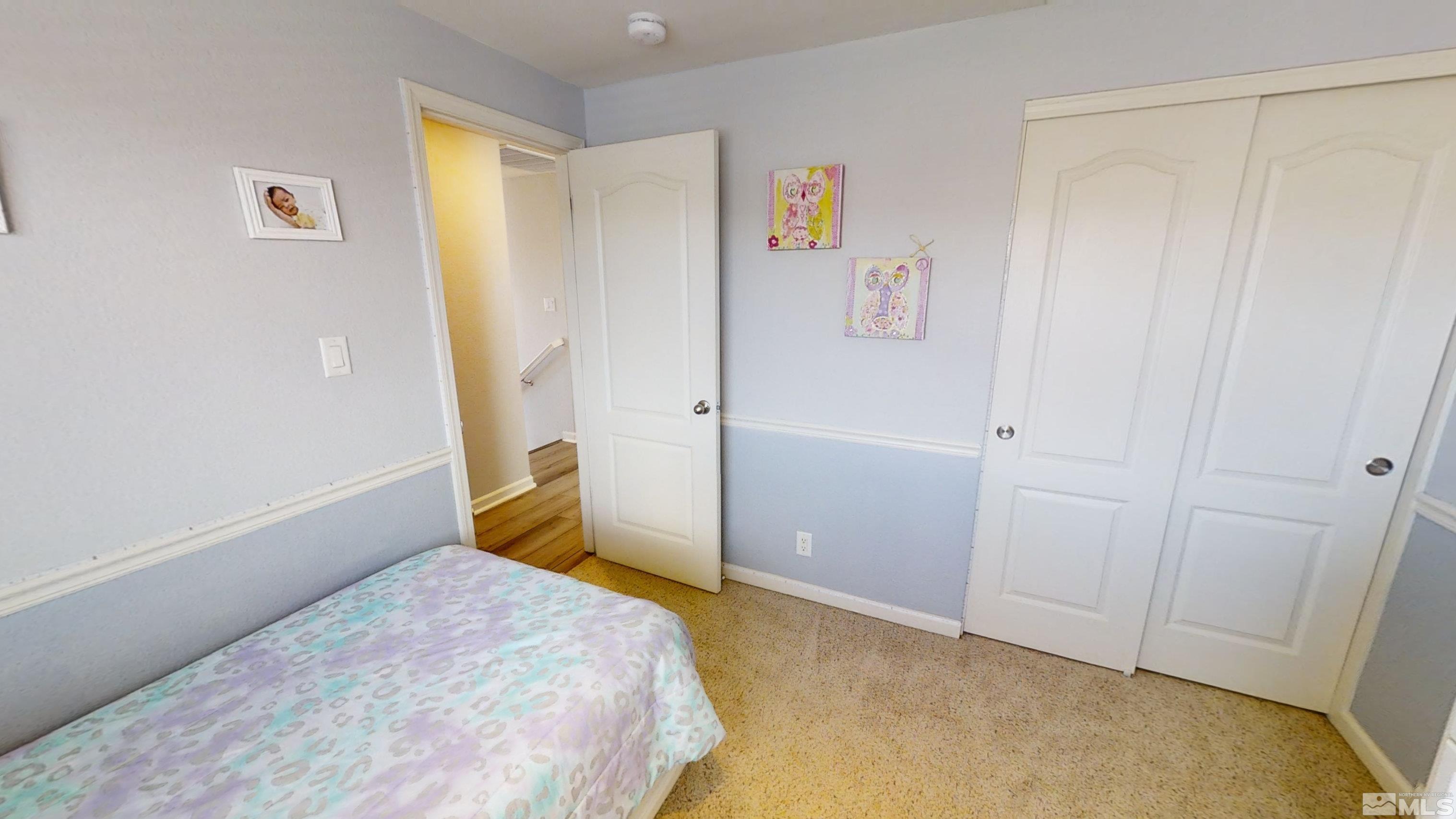10018 Silver Star Drive Reno, NV 89521 - Photo 25 of 38 a bedroom with a bed and hallway