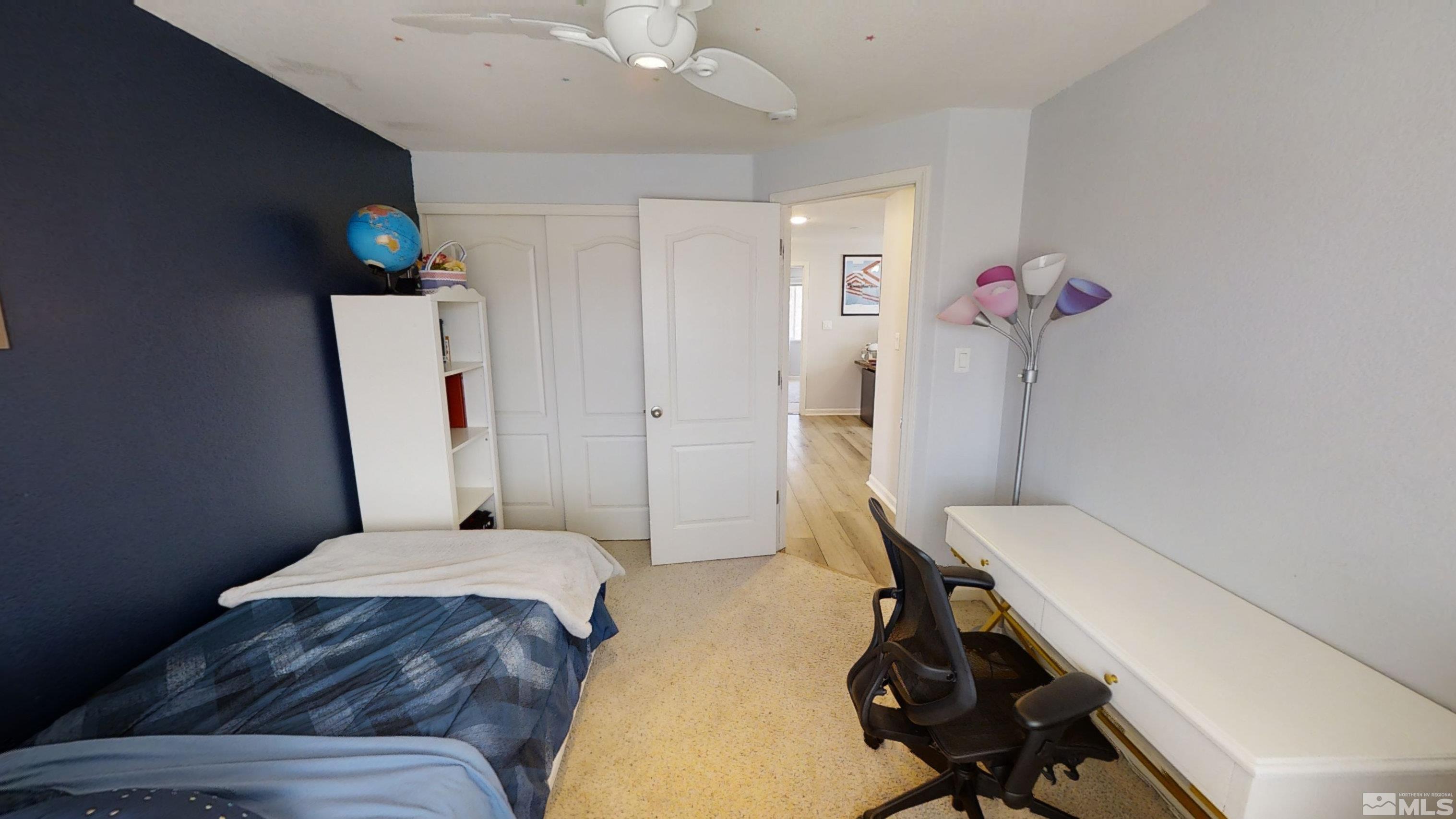 10018 Silver Star Drive Reno, NV 89521 - Photo 27 of 38 a bedroom with a bed and a chandelier