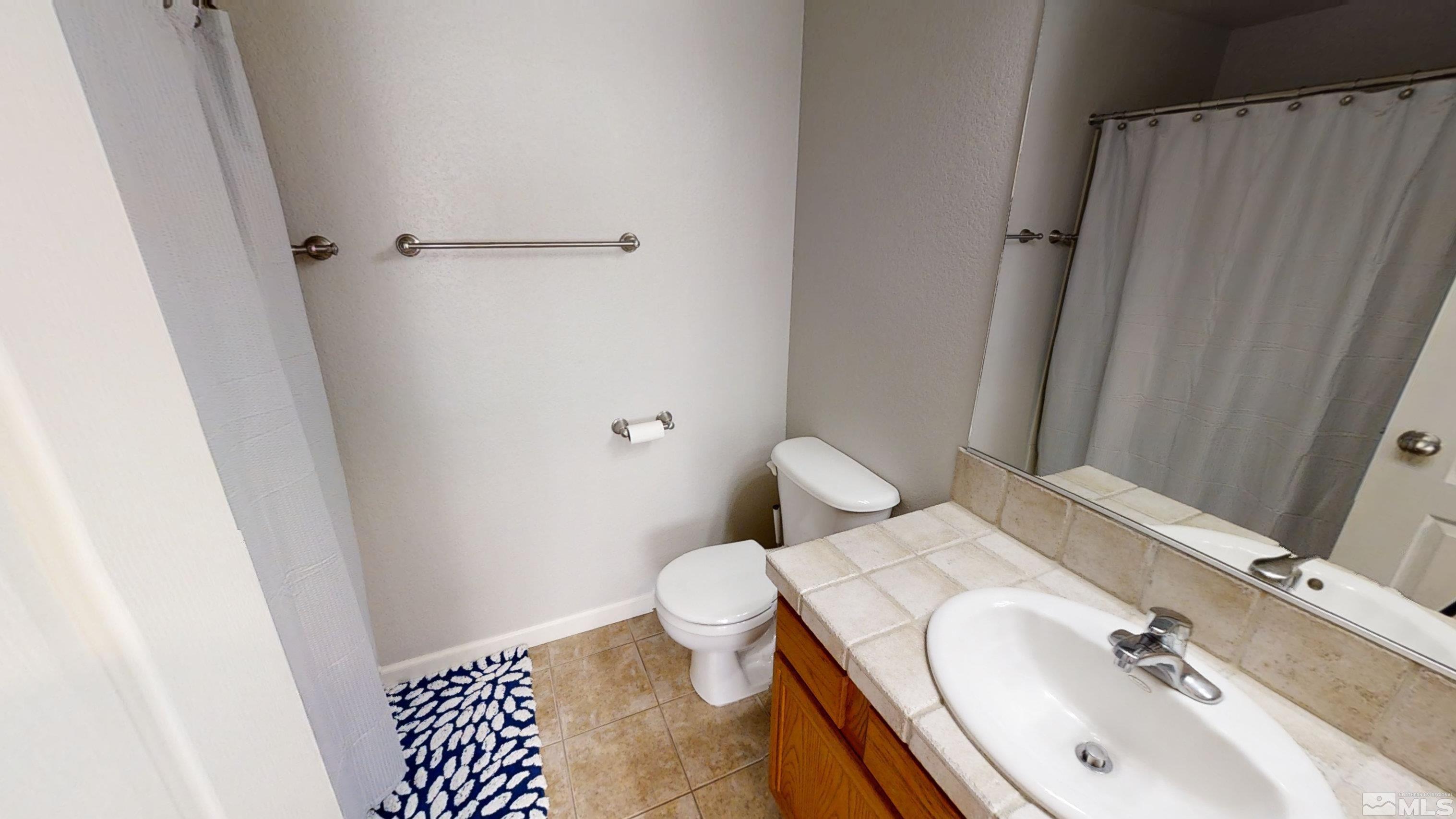 10018 Silver Star Drive Reno, NV 89521 - Photo 28 of 38 a bathroom with a sink toilet and shower