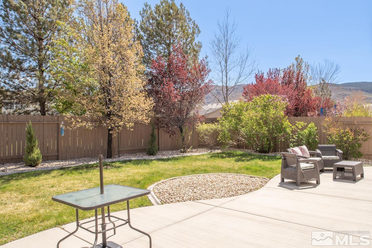 10018 Silver Star Drive Reno, NV 89521 - Photo 30 of 38 a swimming pool with plants and trees in the background