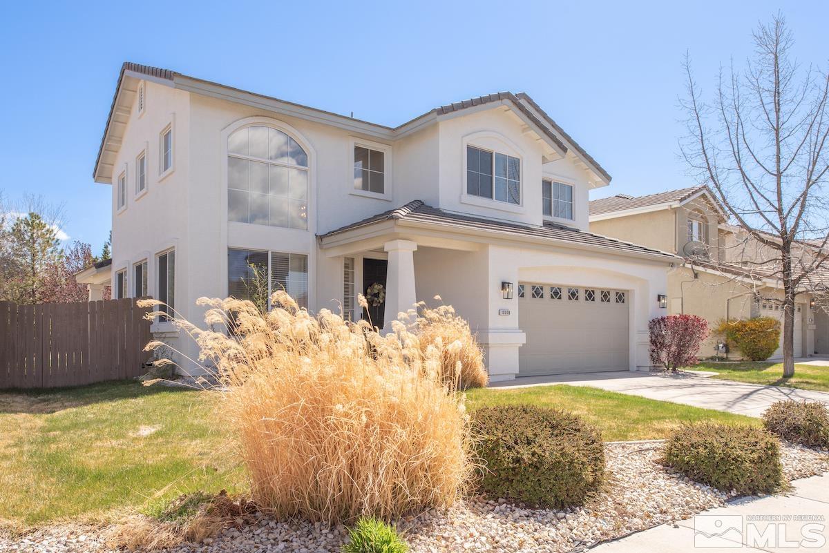 10018 Silver Star Drive Reno, NV 89521 - Photo 3 of 38 a front view of a house with a yard
