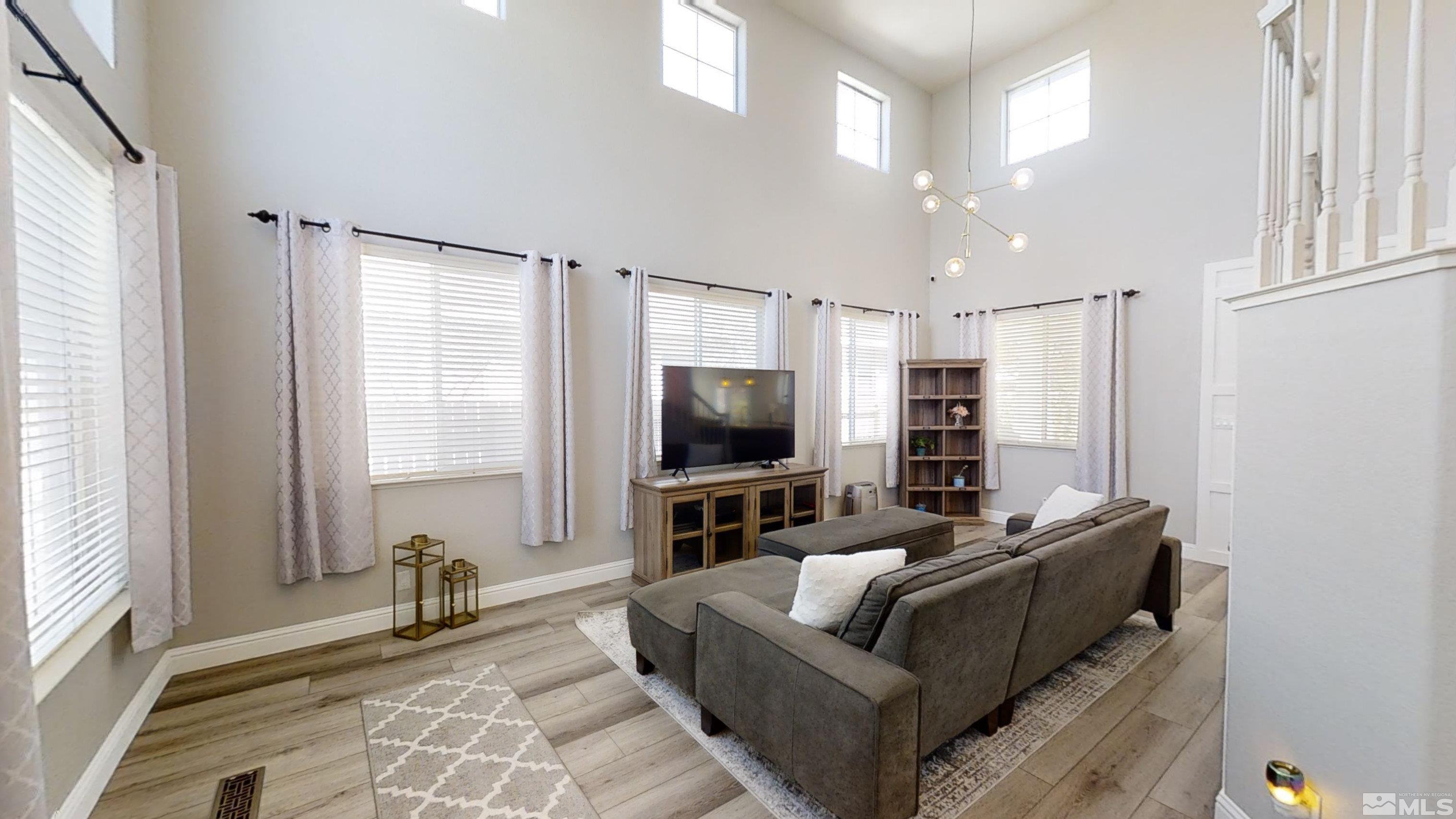 10018 Silver Star Drive Reno, NV 89521 - Photo 5 of 38 a living room with furniture and a flat screen tv