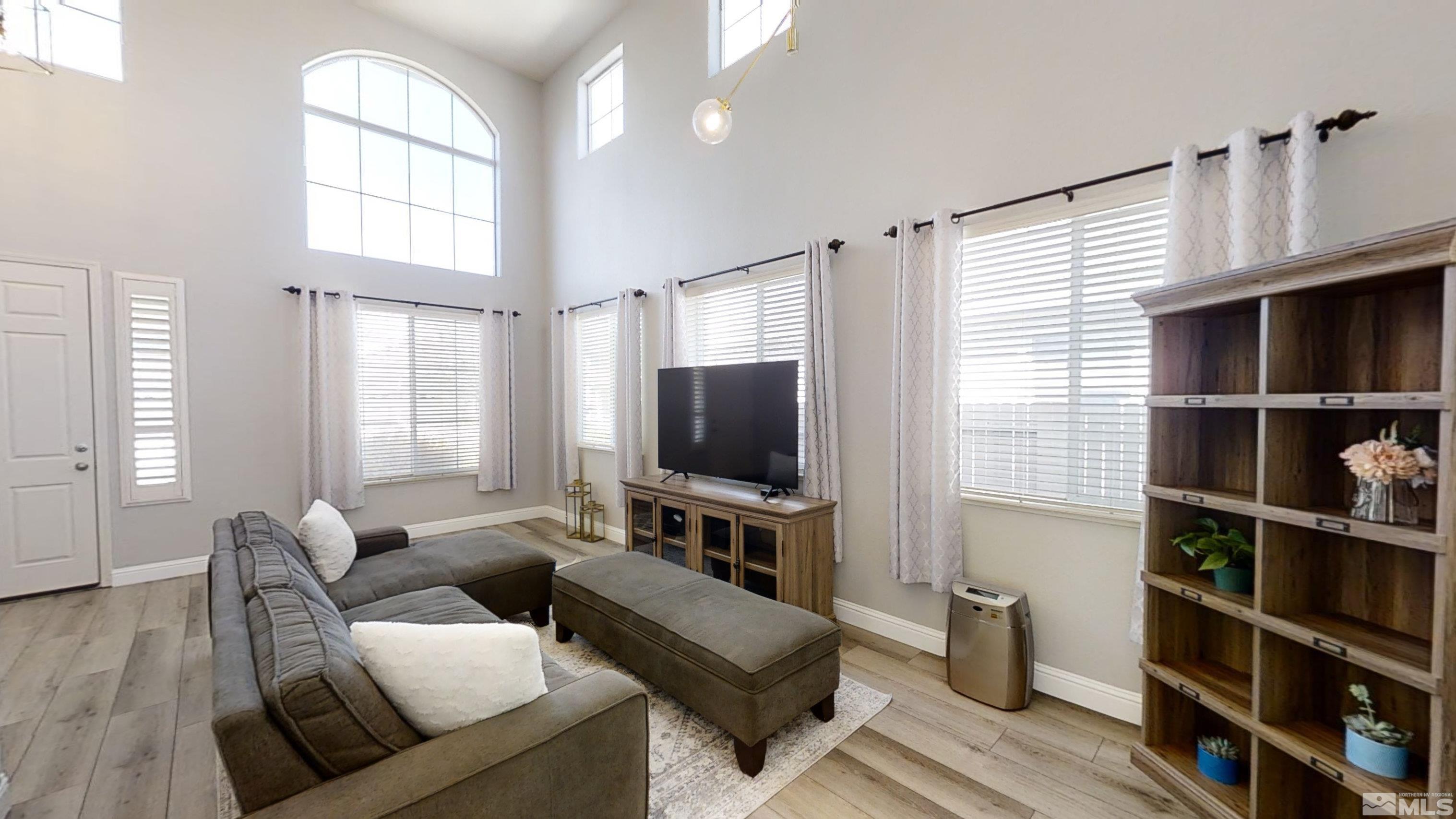 10018 Silver Star Drive Reno, NV 89521 - Photo 7 of 38 a living room with furniture a window and a flat screen tv