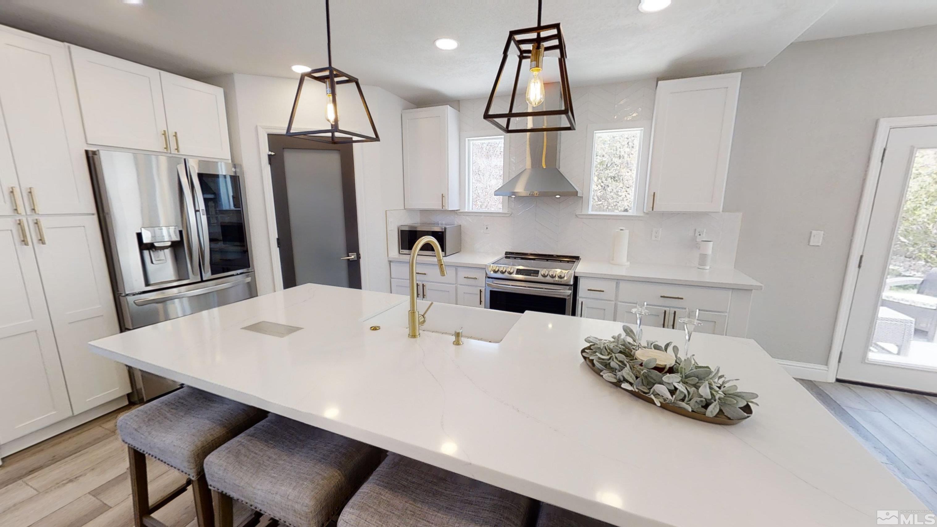 10018 Silver Star Drive Reno, NV 89521 - Photo 10 of 38 a kitchen with stainless steel appliances a sink a table and chairs