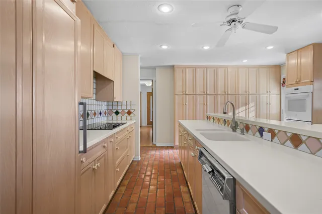 a kitchen with granite countertop a sink stove and cabinets