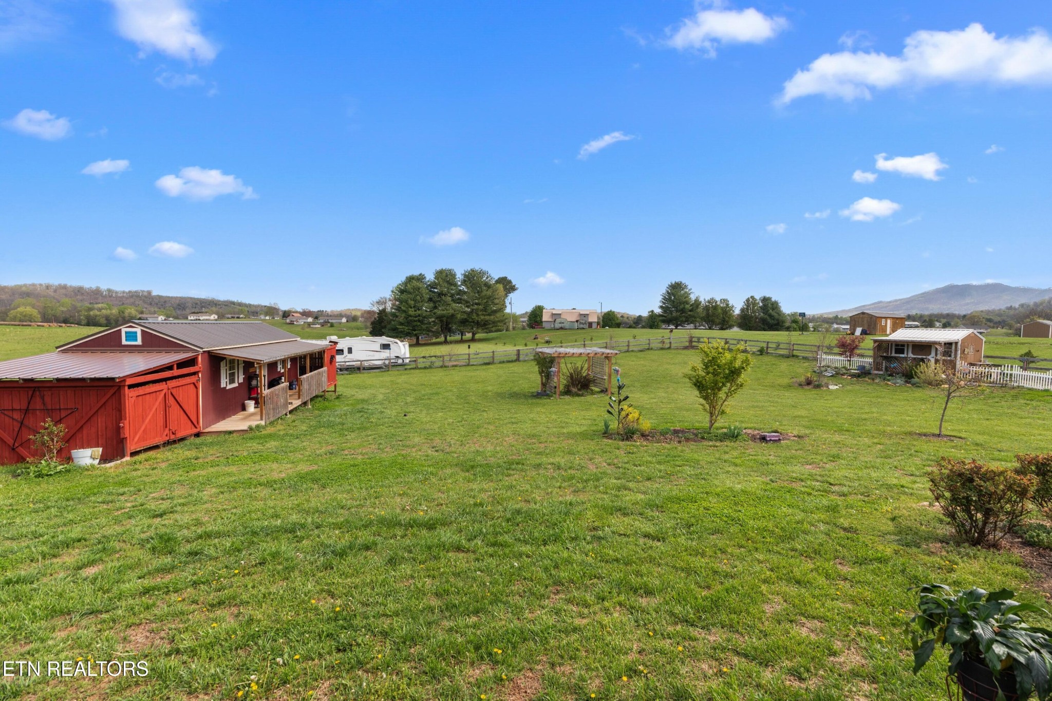 1159 Camellia Road Newport, TN 37821 - Photo 18 of 45 a view of a garden with a building in the background