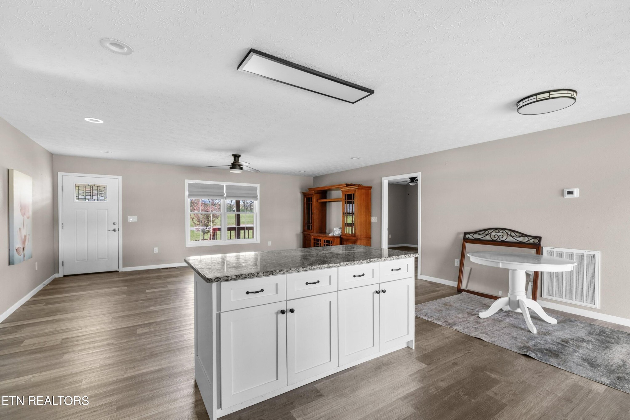 1159 Camellia Road Newport, TN 37821 - Photo 30 of 45 a kitchen with granite countertop a stove a sink and a refrigerator