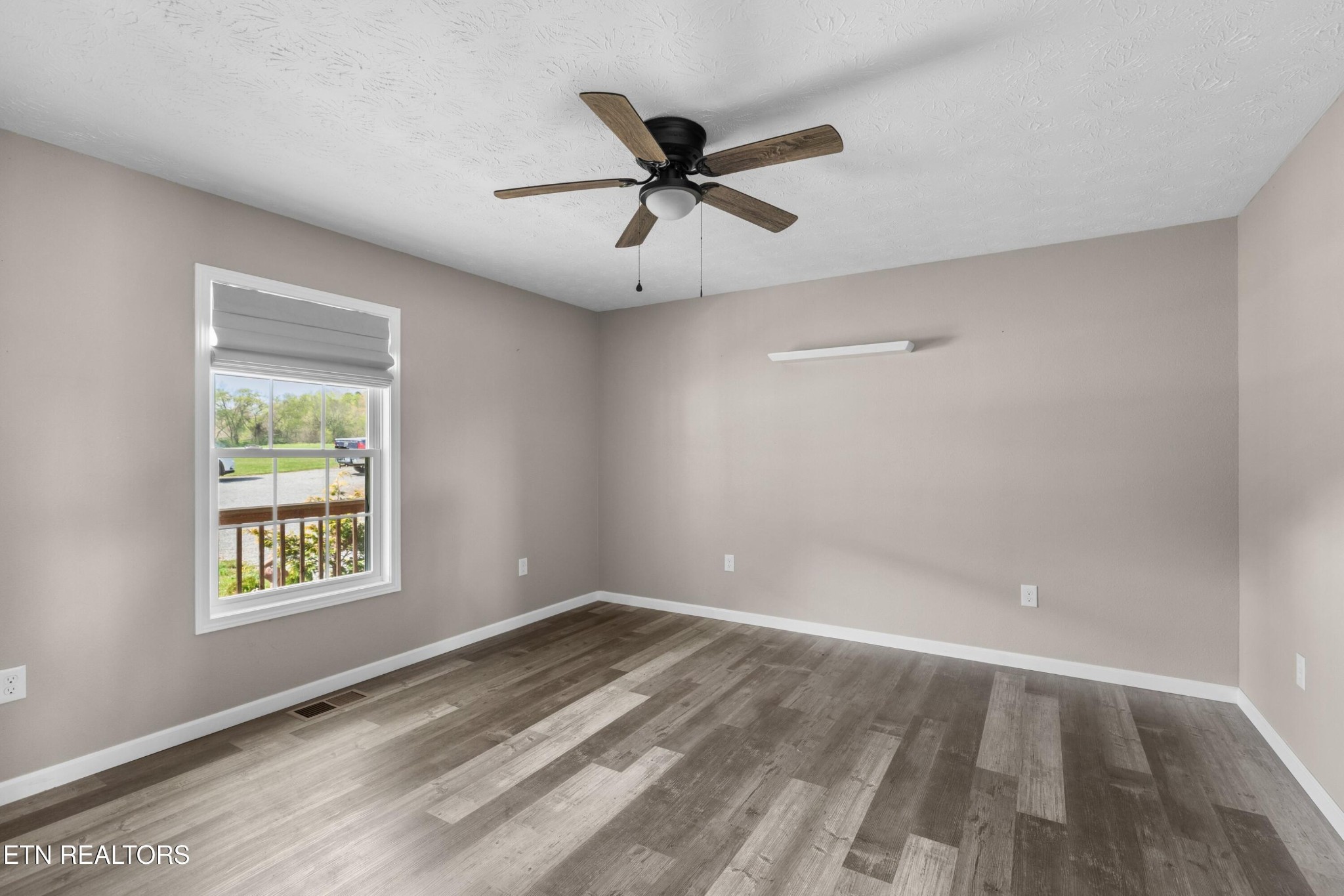 1159 Camellia Road Newport, TN 37821 - Photo 33 of 45 an empty room with a window and a ceiling fan