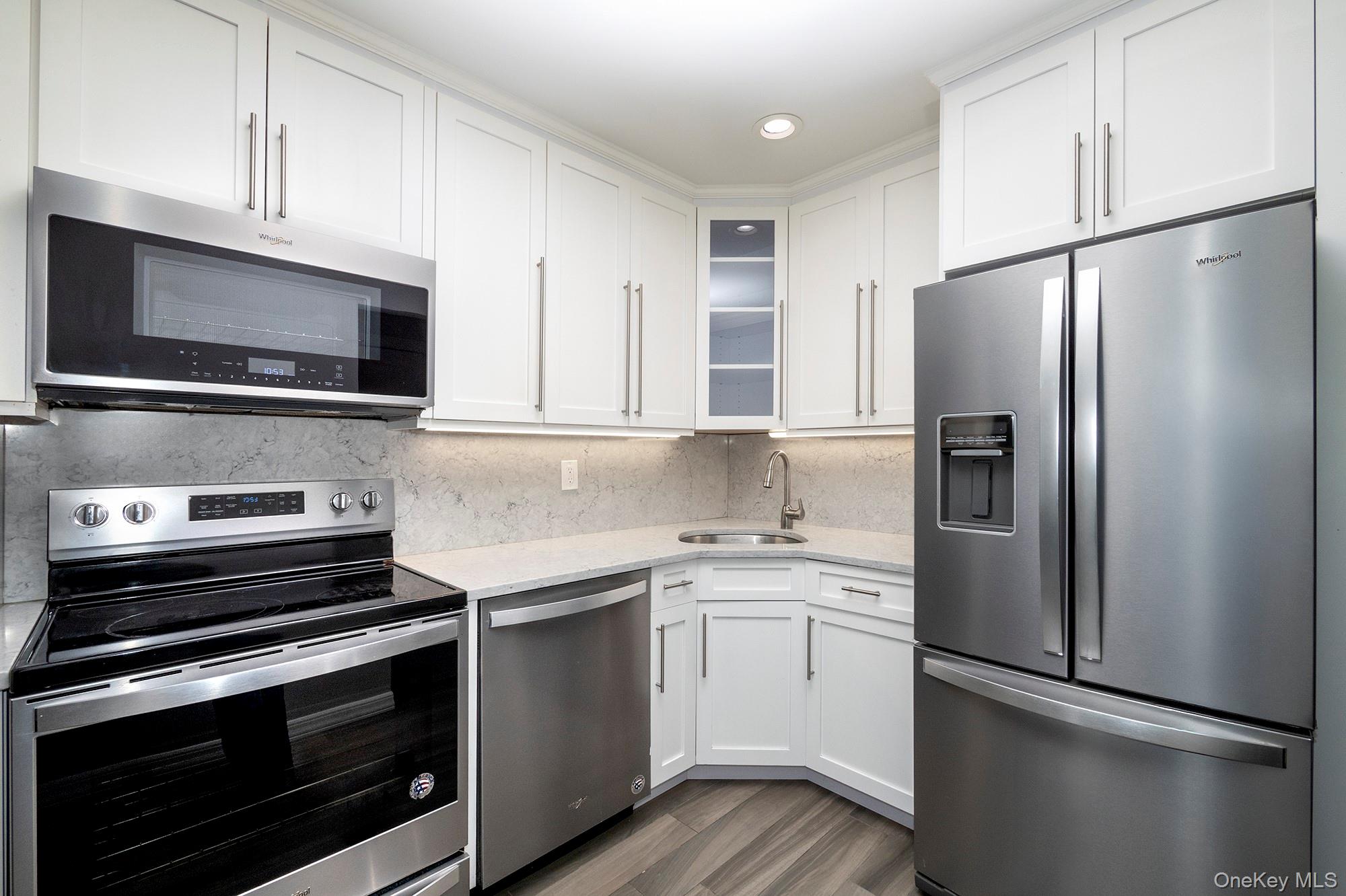 425 Newbridge Road, Unit 37 East Meadow, NY 11554 - Photo 2 of 8 a kitchen with a refrigerator stove and microwave