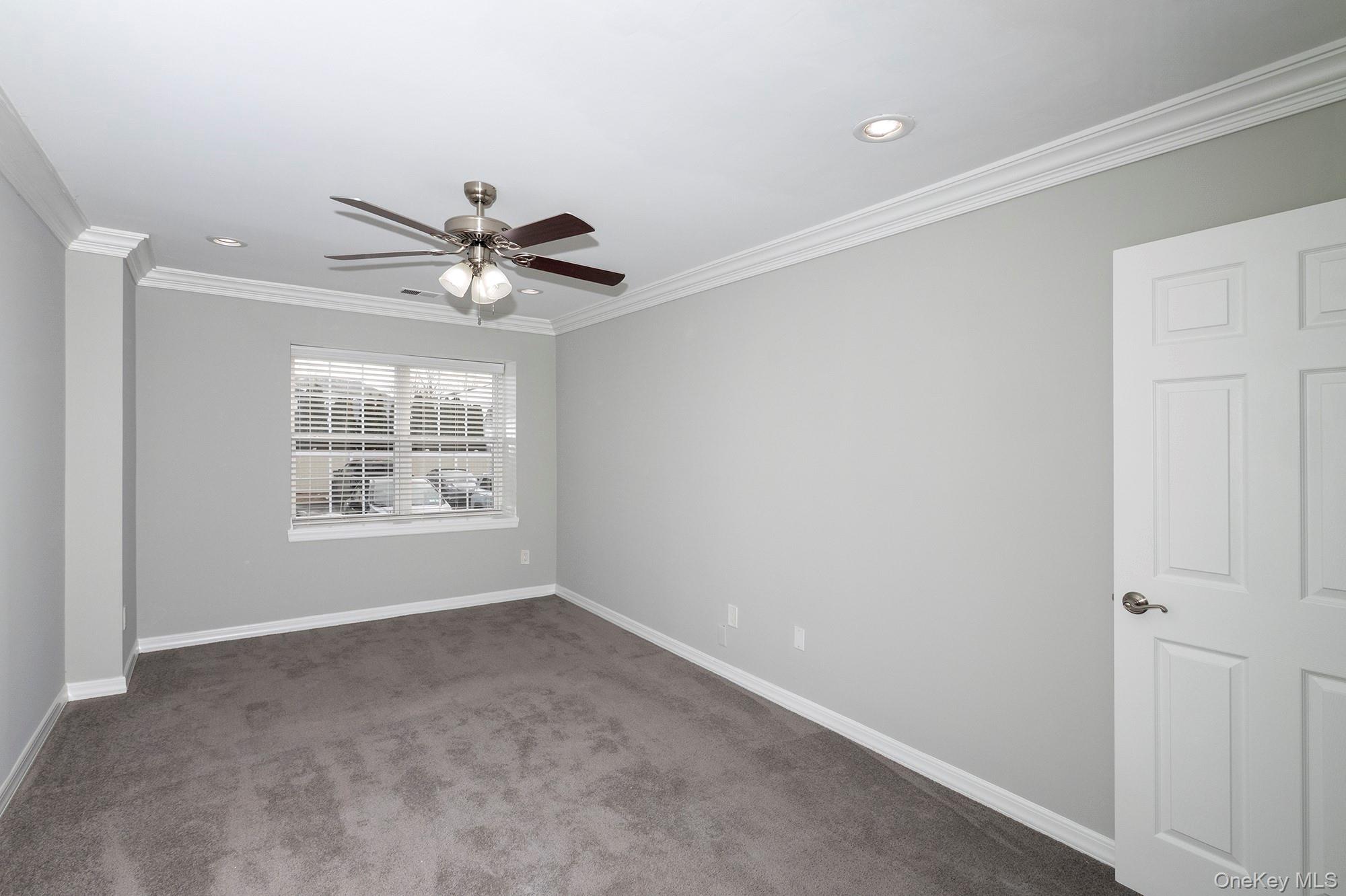 425 Newbridge Road, Unit 37 East Meadow, NY 11554 - Photo 5 of 8 a view of an empty room with a window
