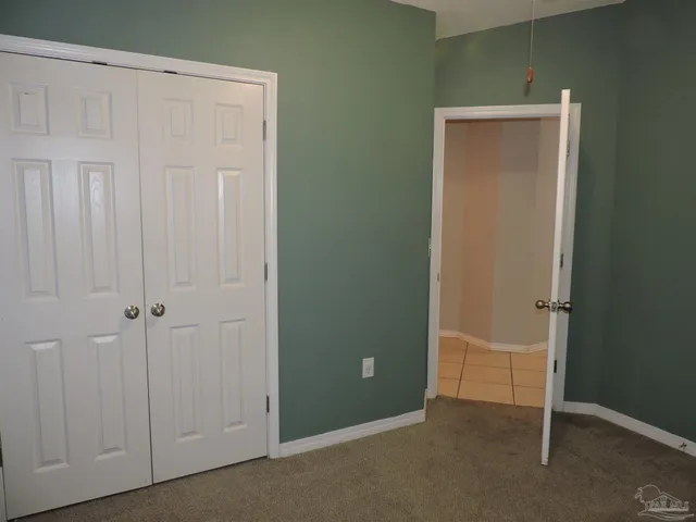 an empty room with closet area