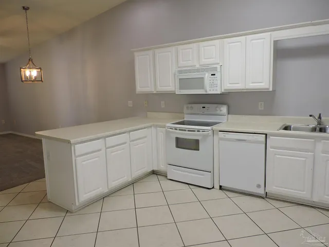 a kitchen with white cabinets