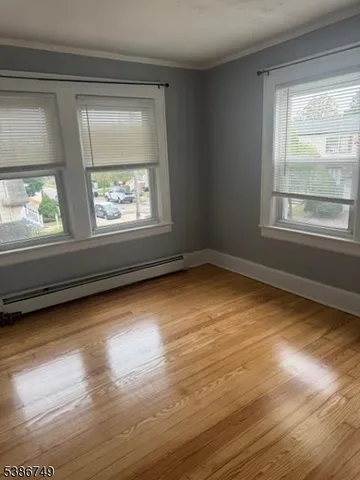 a view of room with window and hardwood floor