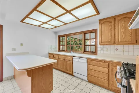 a kitchen that has a sink and a stove in it