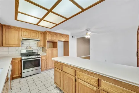 a kitchen with stainless steel appliances granite countertop a sink stove and cabinets