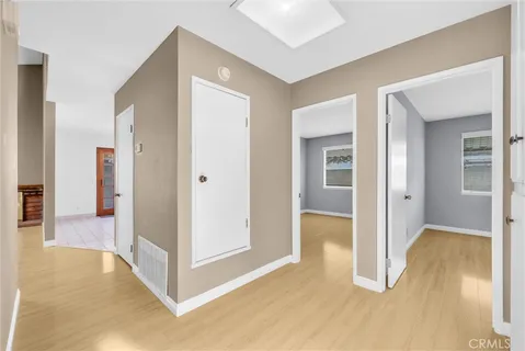 a view of a hallway with wooden floor