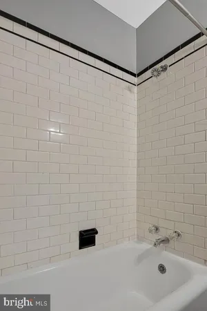 a bathroom with a shower and a sink