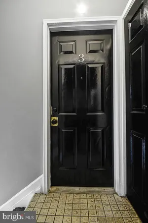 a view of a hallway with wooden door