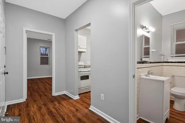 a view of bathroom with toilet sink and mirror