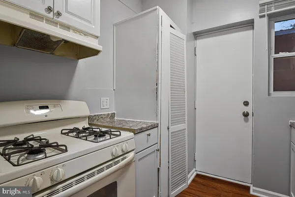 a kitchen with a stove and a refrigerator