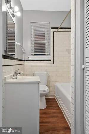 a bathroom with a sink a toilet and bathtub