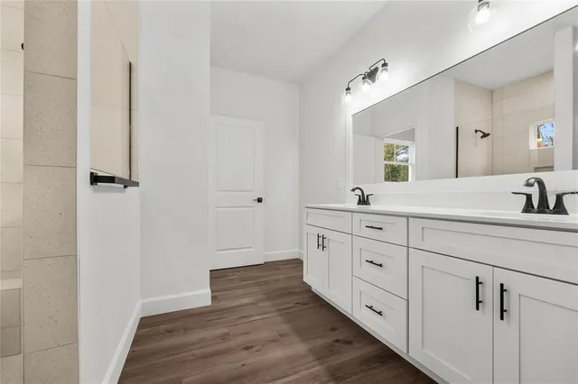 a spacious bathroom with double sink and a mirror