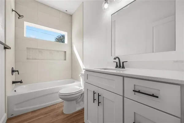 a bathroom with a sink a toilet and a bathtub