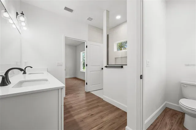 a view of a bathroom with a sink toilet and a bathtub