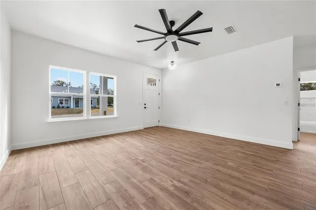 wooden floor in an empty room with a window
