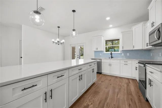 a kitchen with sink cabinets and window