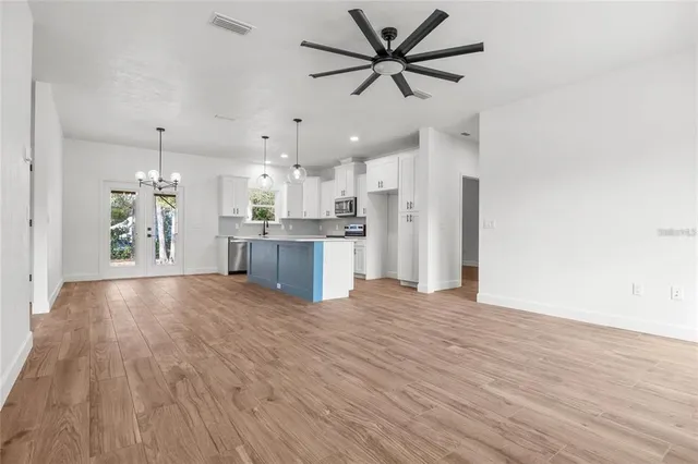 a view of a kitchen with a sink and a refrigerator