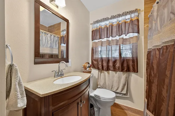 a bathroom with a sink toilet and shower