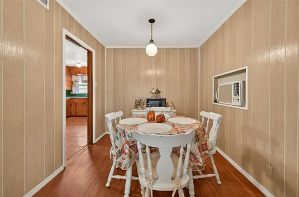 a view of a dining room with furniture wooden floor and window