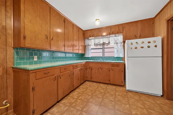 a kitchen with a refrigerator and a cabinets