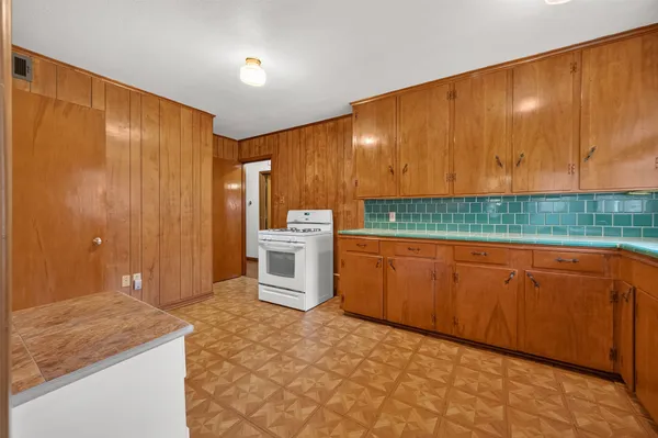a room with sink and cabinets