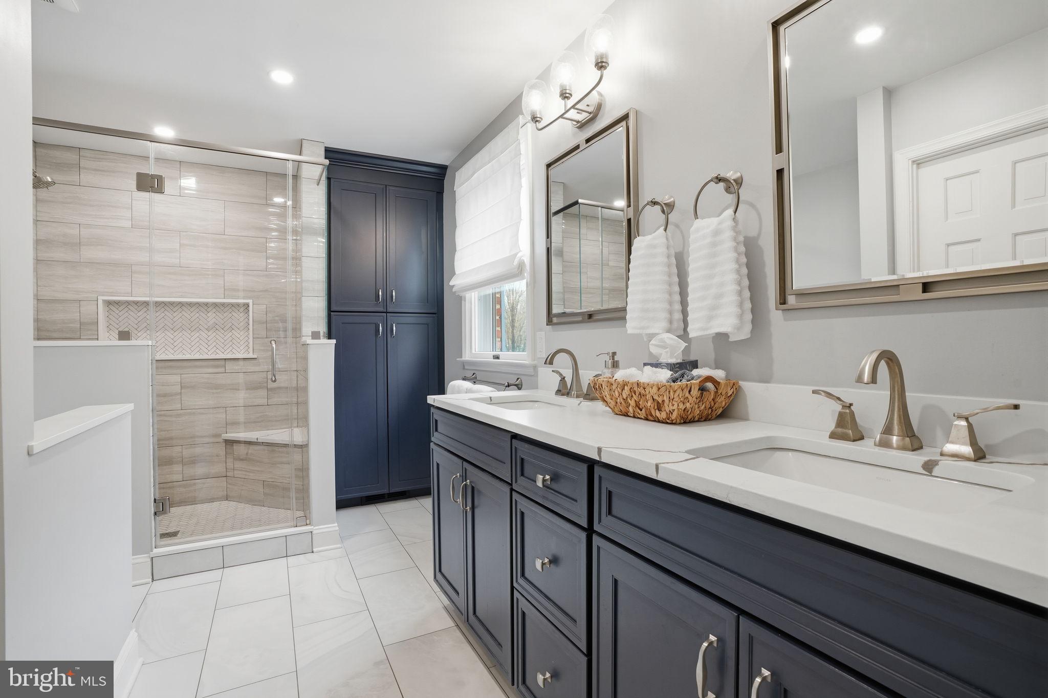 1431 Silo Road Yardley, PA 19067 - Photo 14 of 32 a bathroom with a double vanity sink a mirror and a shower