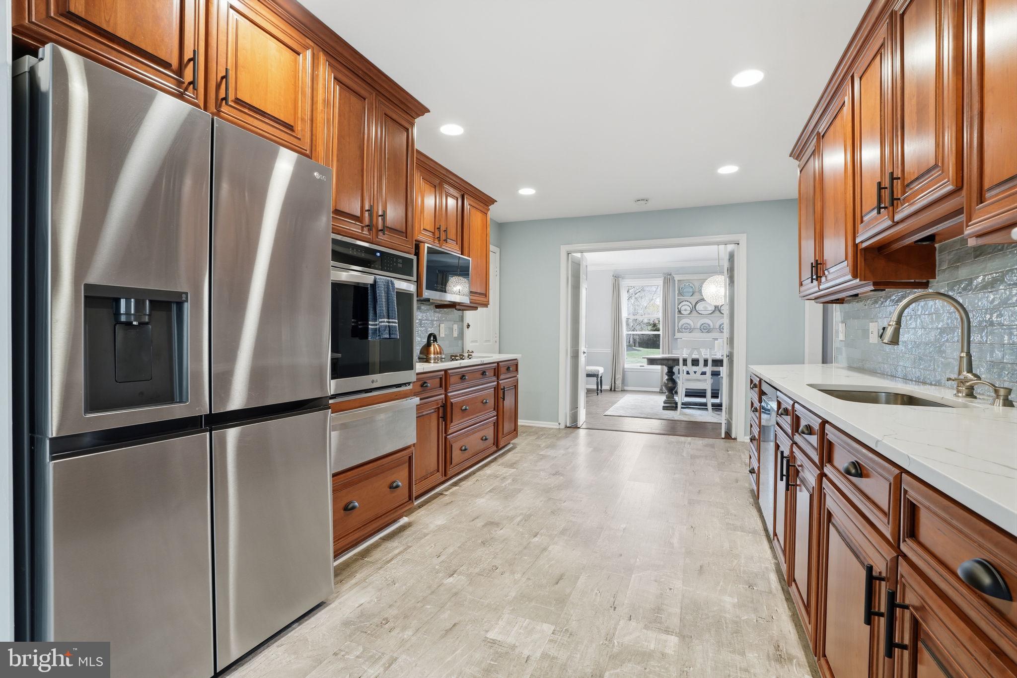 1431 Silo Road Yardley, PA 19067 - Photo 7 of 32 a kitchen with stainless steel appliances granite countertop a refrigerator a stove and a sink