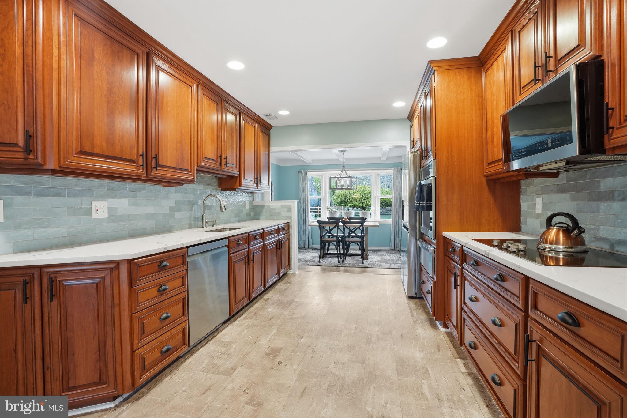 1431 Silo Road Yardley, PA 19067 - Photo 8 of 32 a kitchen with stainless steel appliances granite countertop a stove a sink and a microwave