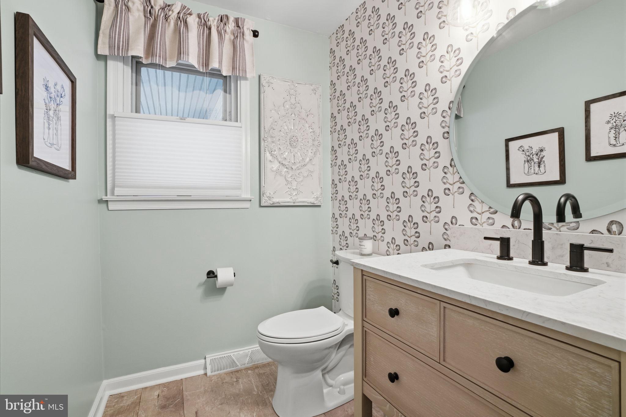 1431 Silo Road Yardley, PA 19067 - Photo 10 of 32 a bathroom with a sink a toilet and mirror