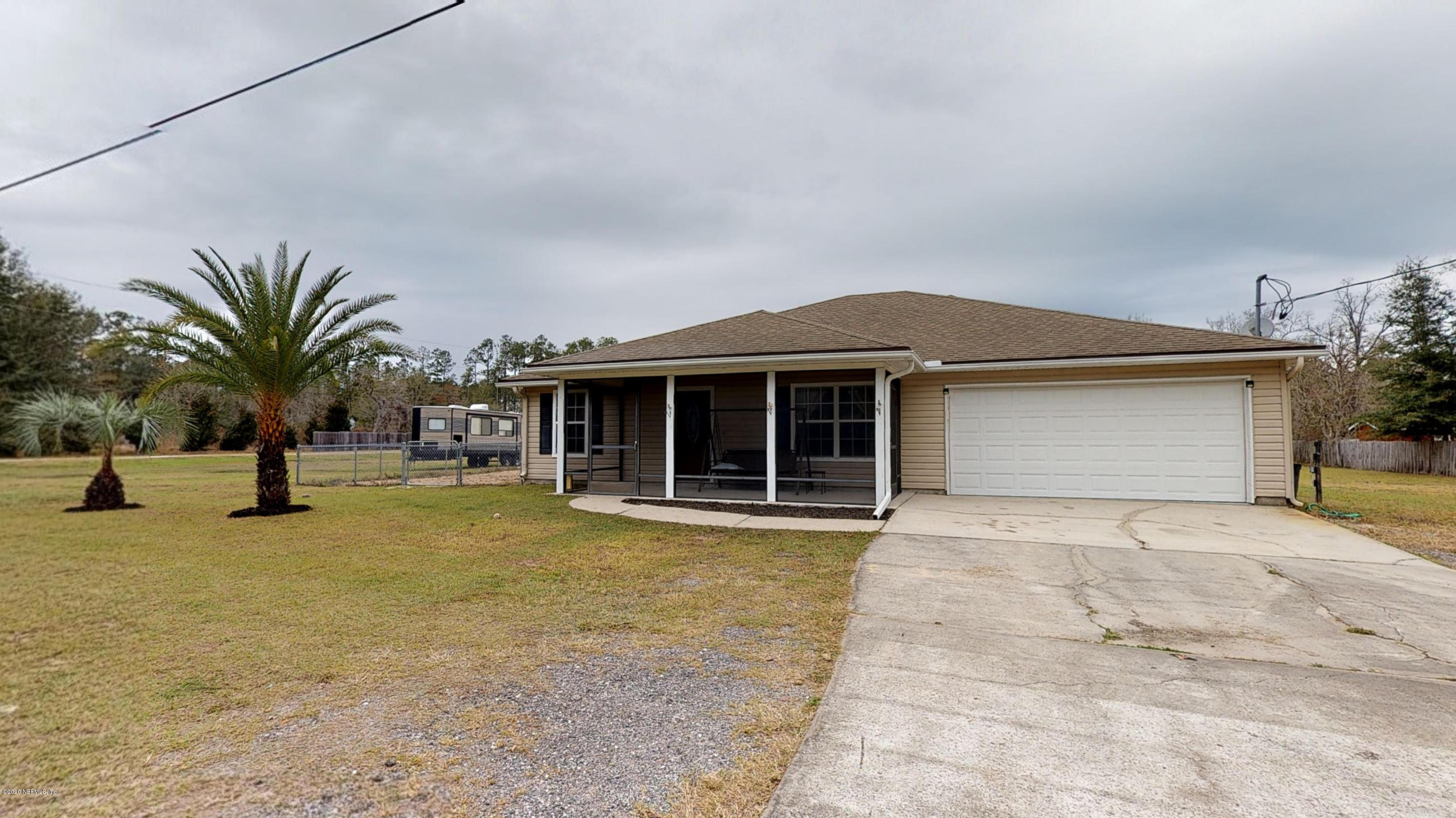 3990 Bronco Road Middleburg, FL 32068 - Photo 1 of 40 a view of a house with a swimming pool and sitting area