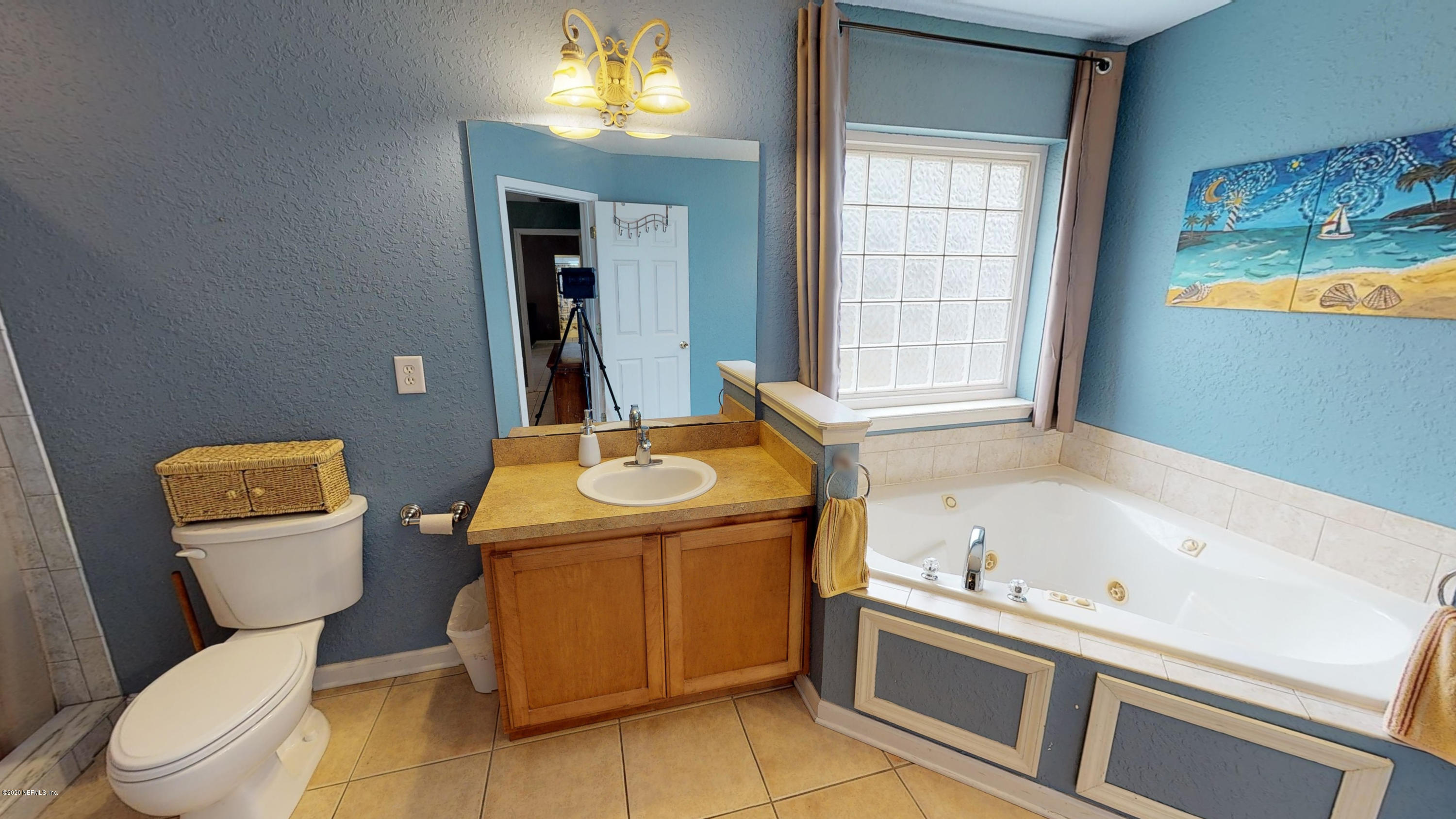 3990 Bronco Road Middleburg, FL 32068 - Photo 21 of 40 a bathroom with a sink toilet and window