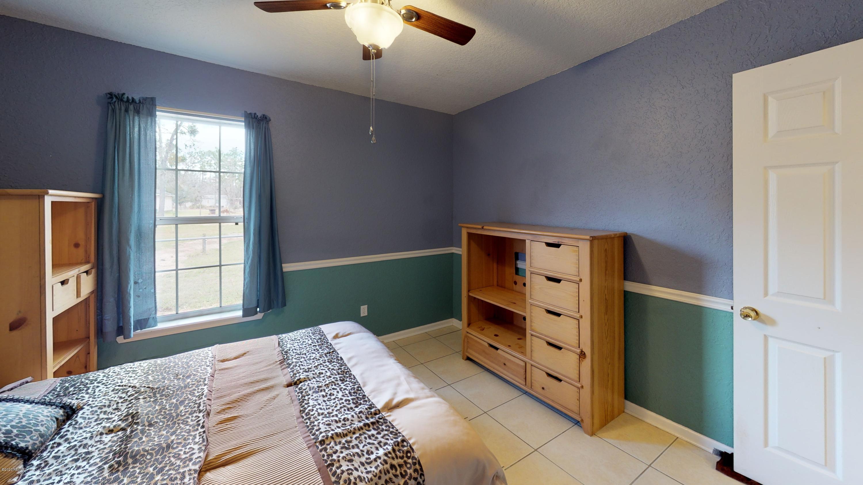 3990 Bronco Road Middleburg, FL 32068 - Photo 27 of 40 a bedroom with a bed and a window