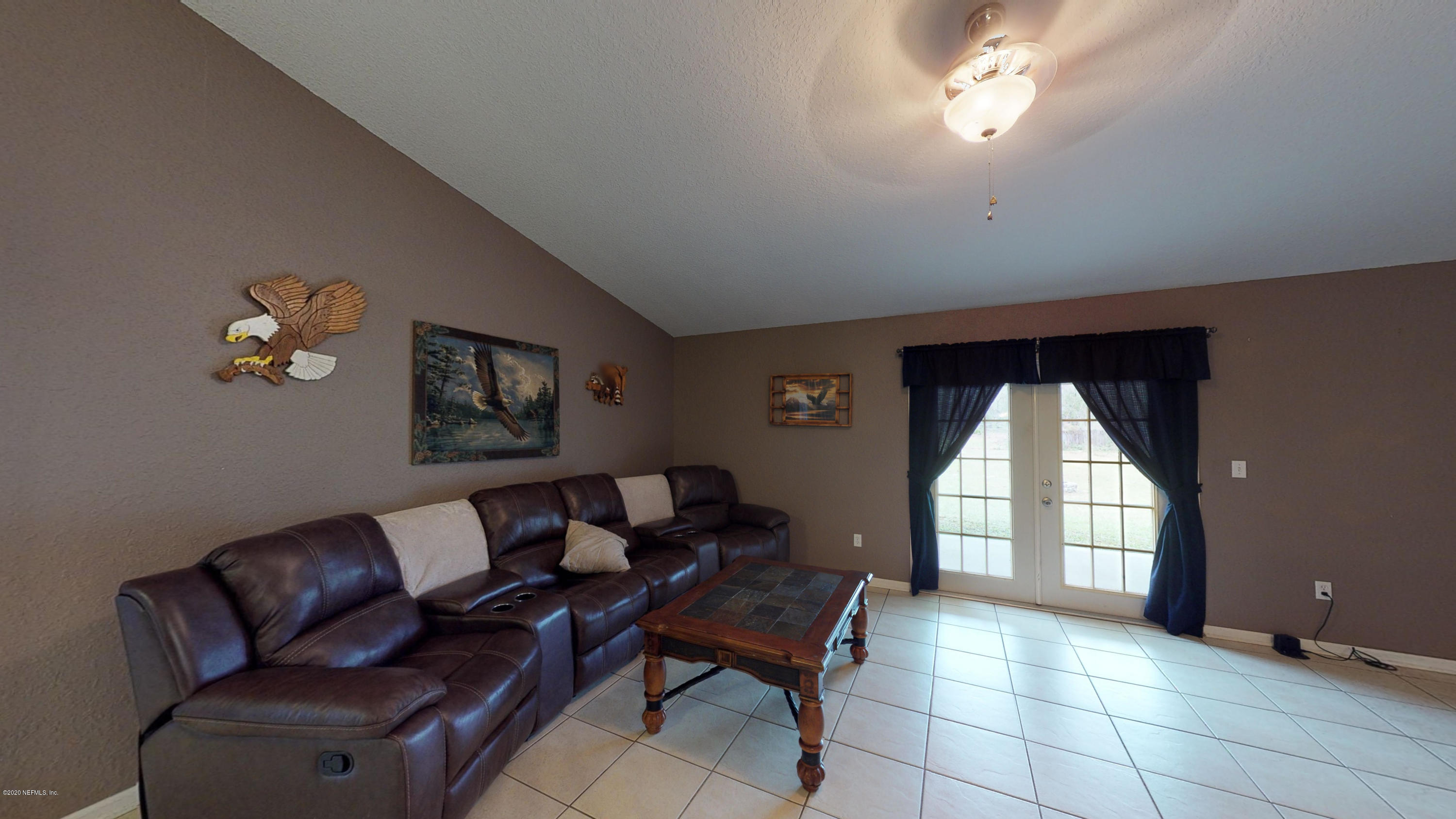 3990 Bronco Road Middleburg, FL 32068 - Photo 4 of 40 a living room with furniture and a large window