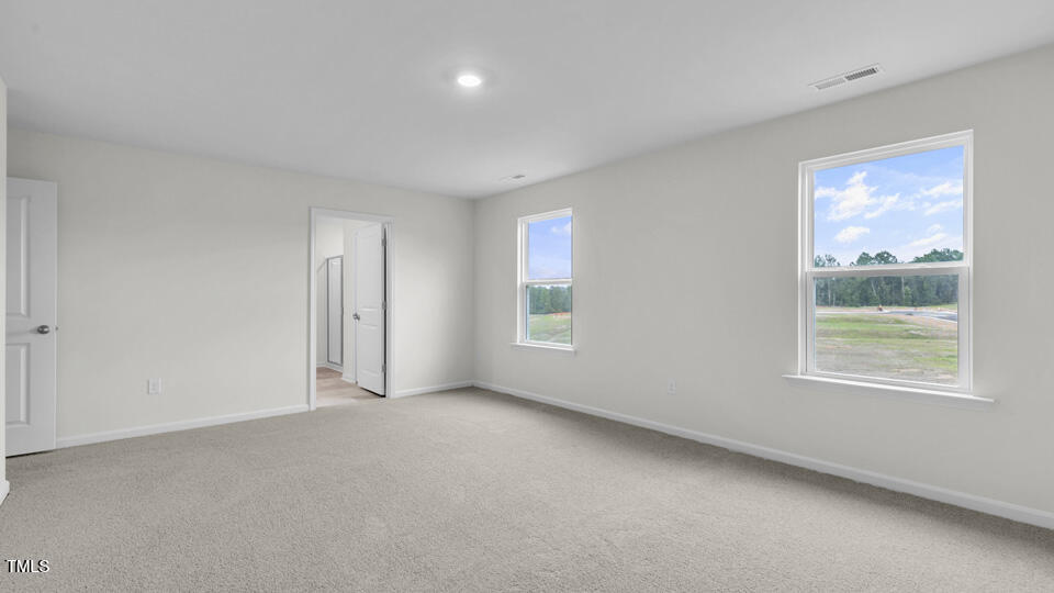 812 Comice Pear Way Willow Spring, NC 27592 - Photo 19 of 42 a view of an empty room with a window
