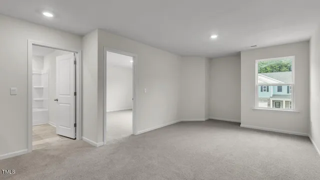 an empty room with windows and closet